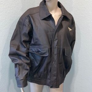 Burks Bay  leather brown coat has a patch on the left side.